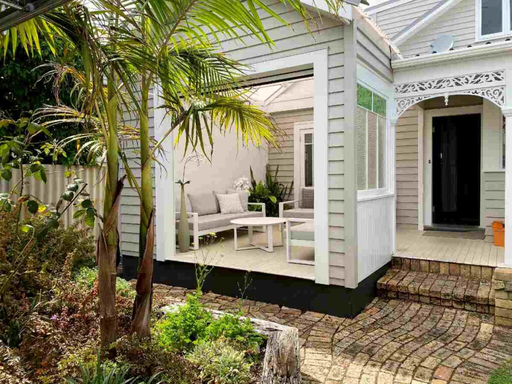 Beautifully completed all-season outdoor room with Outside Space NZ Unwind lounge suite and Sunbrella cushions.