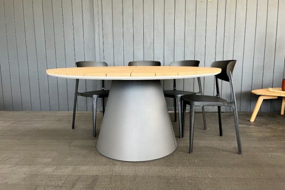 designer round teak top outdoor table.