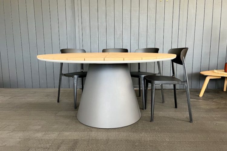 designer round teak top outdoor table.